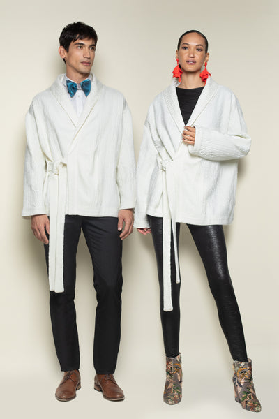 Front view of Ivory Cable Knit Cardigan worn by Male Model and Female Model. Showcases the unique Unisex Look of the Hip Length Cardigan with Tie Front Band