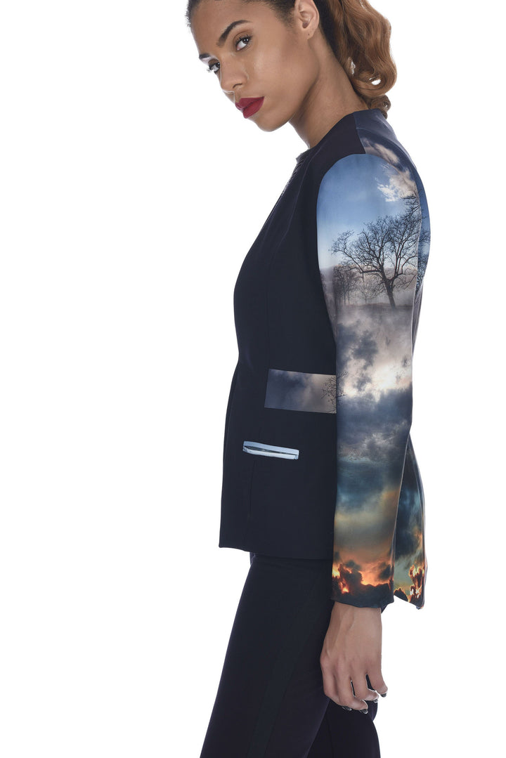 A tailored tuxedo jacket in black and hues of blue, front hook closure and signature sleeves.